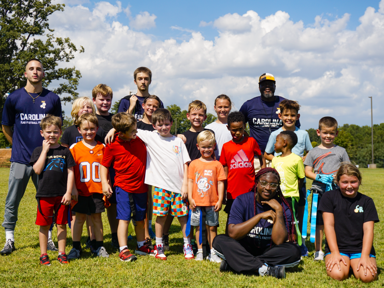 _DSC7107 Flag football program for schools — coach with students on campus.