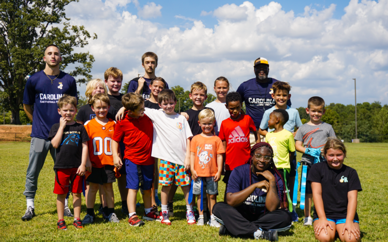_DSC7107 Flag football program for schools — coach with students on campus.